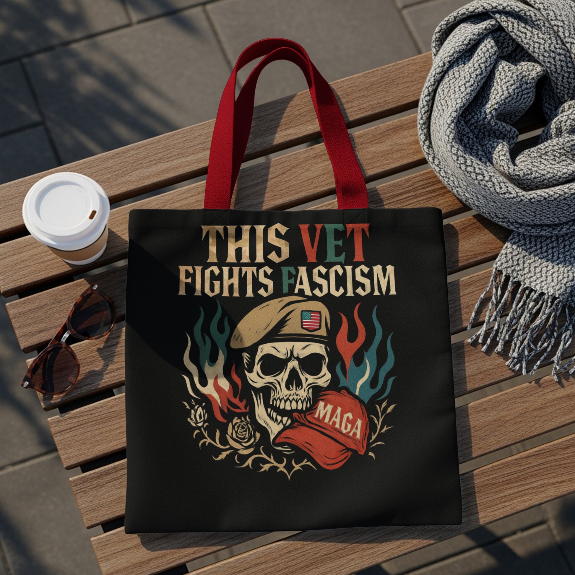 Black tote bag with skull, flag, and "This Vet Fights Fascism" text.