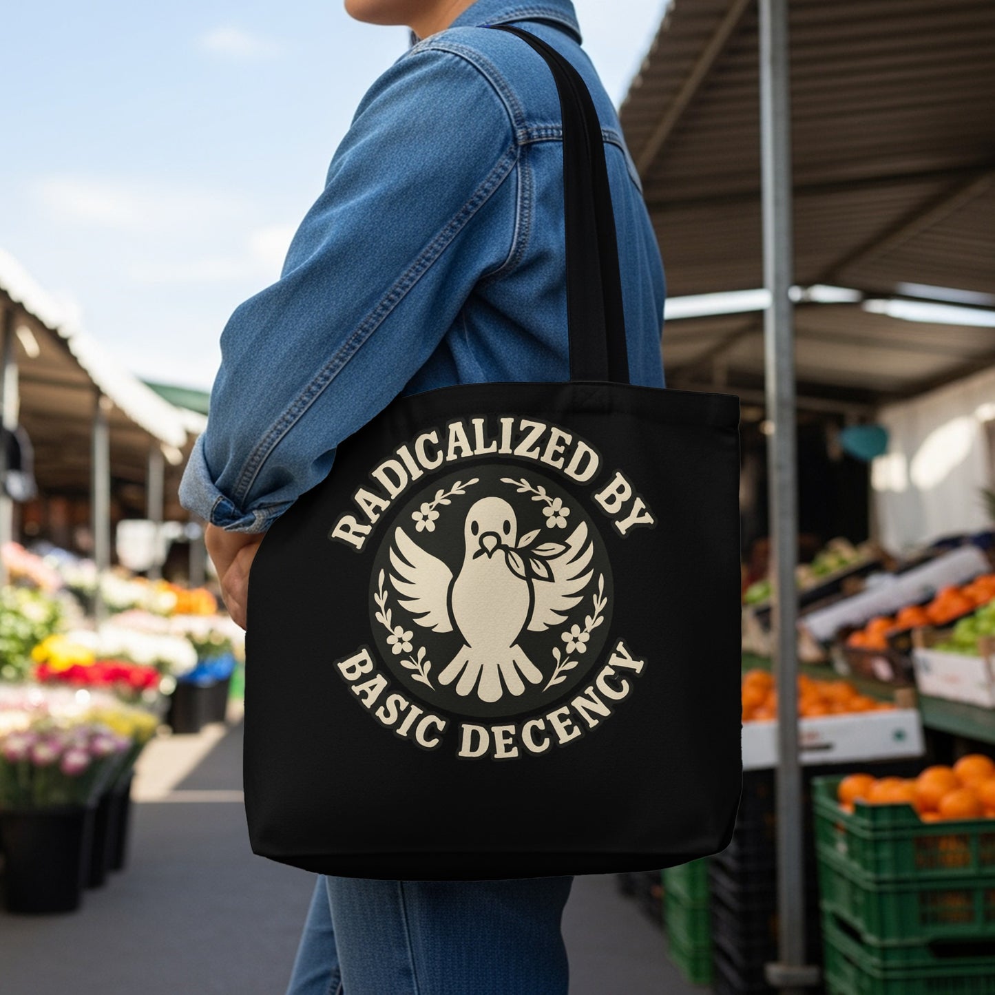 Black tote bag with white text and a dove carrying an olive branch.