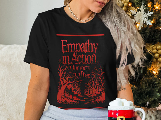 Black t-shirt with red forest graphic and "Empathy in Action" text.