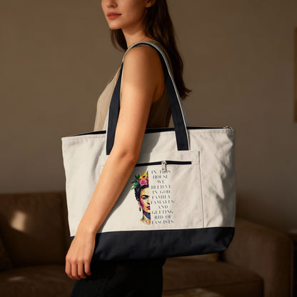 Tote bag with Frida Kahlo artwork and text: "In this house we believe in God, Family, Tamales, and getting rid of Fascists."