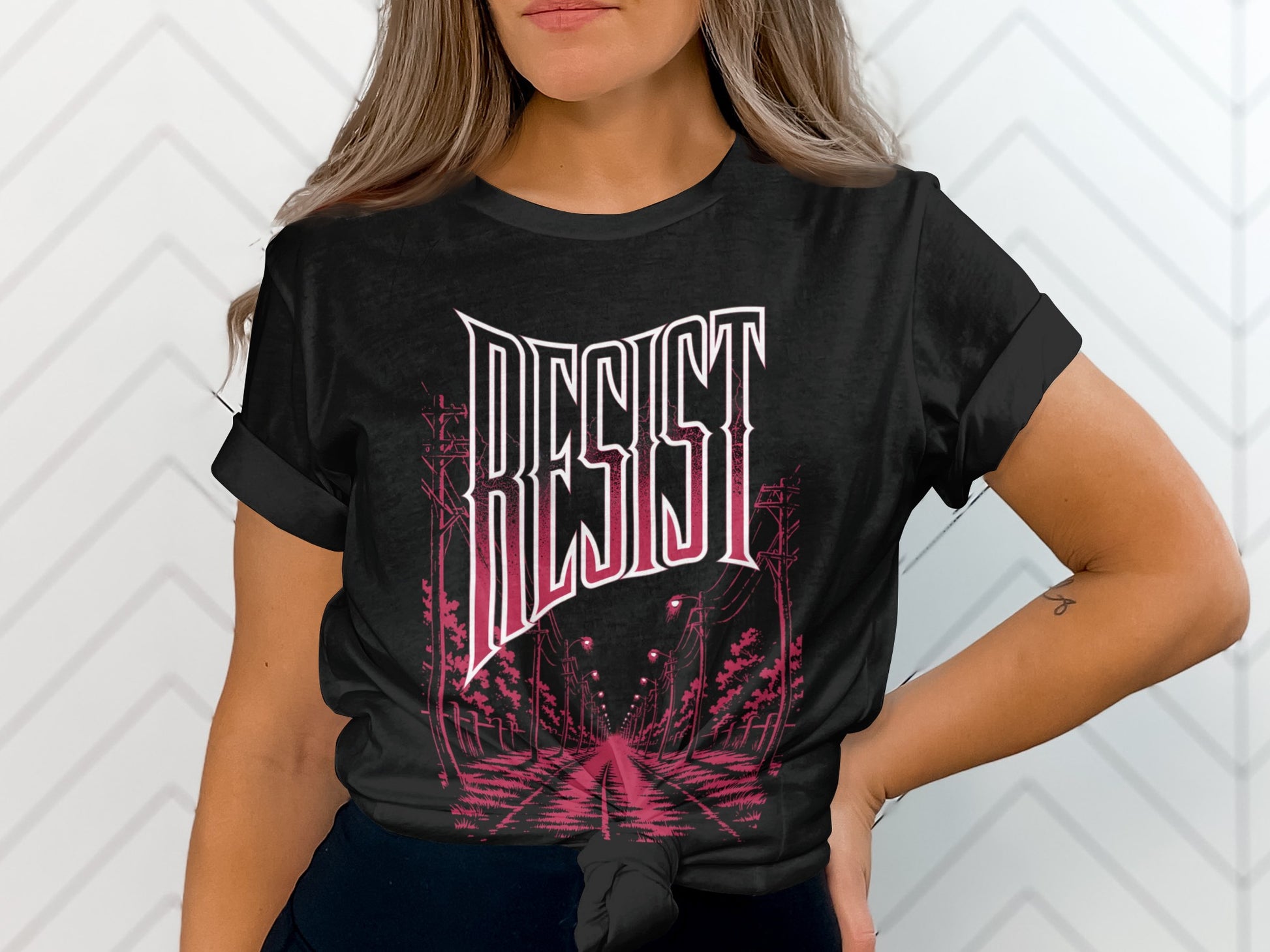 Black t-shirt with "RESIST" text and stylized street scene.