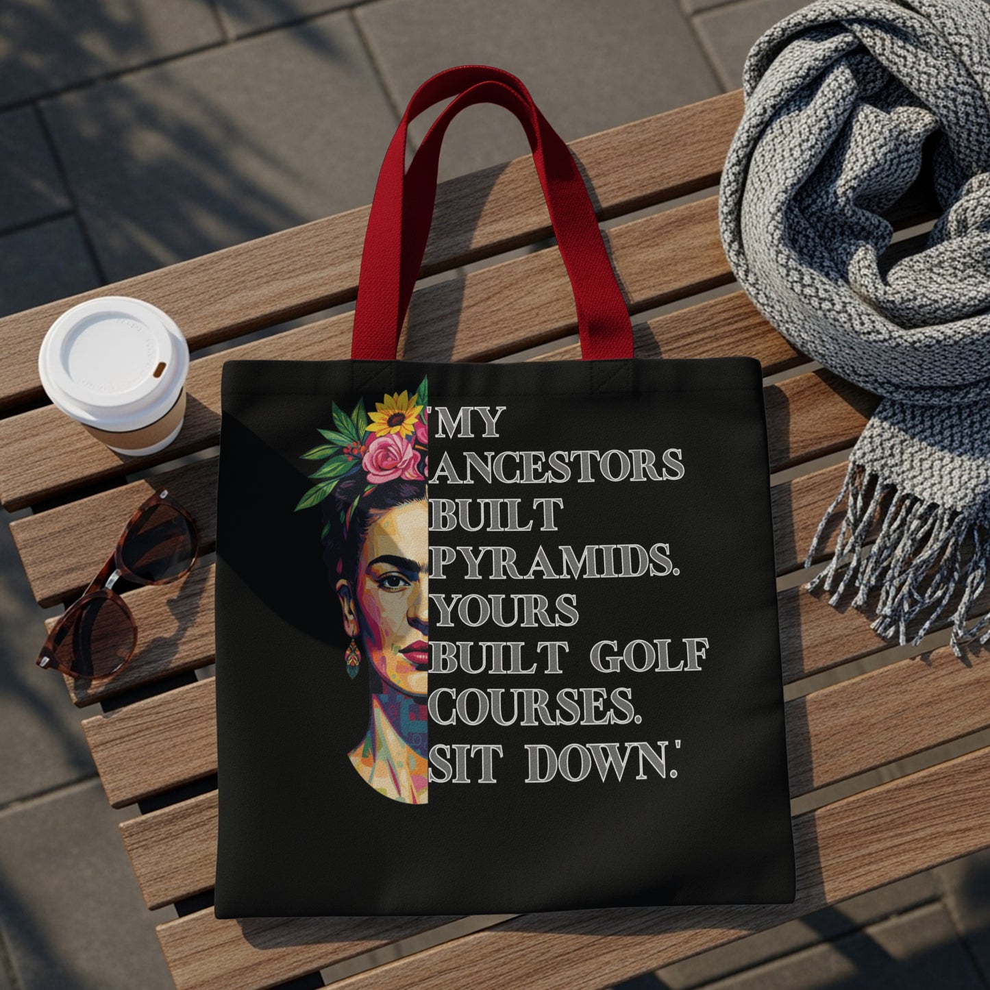 Black tote bag with Frida Kahlo portrait and text about ancestors.