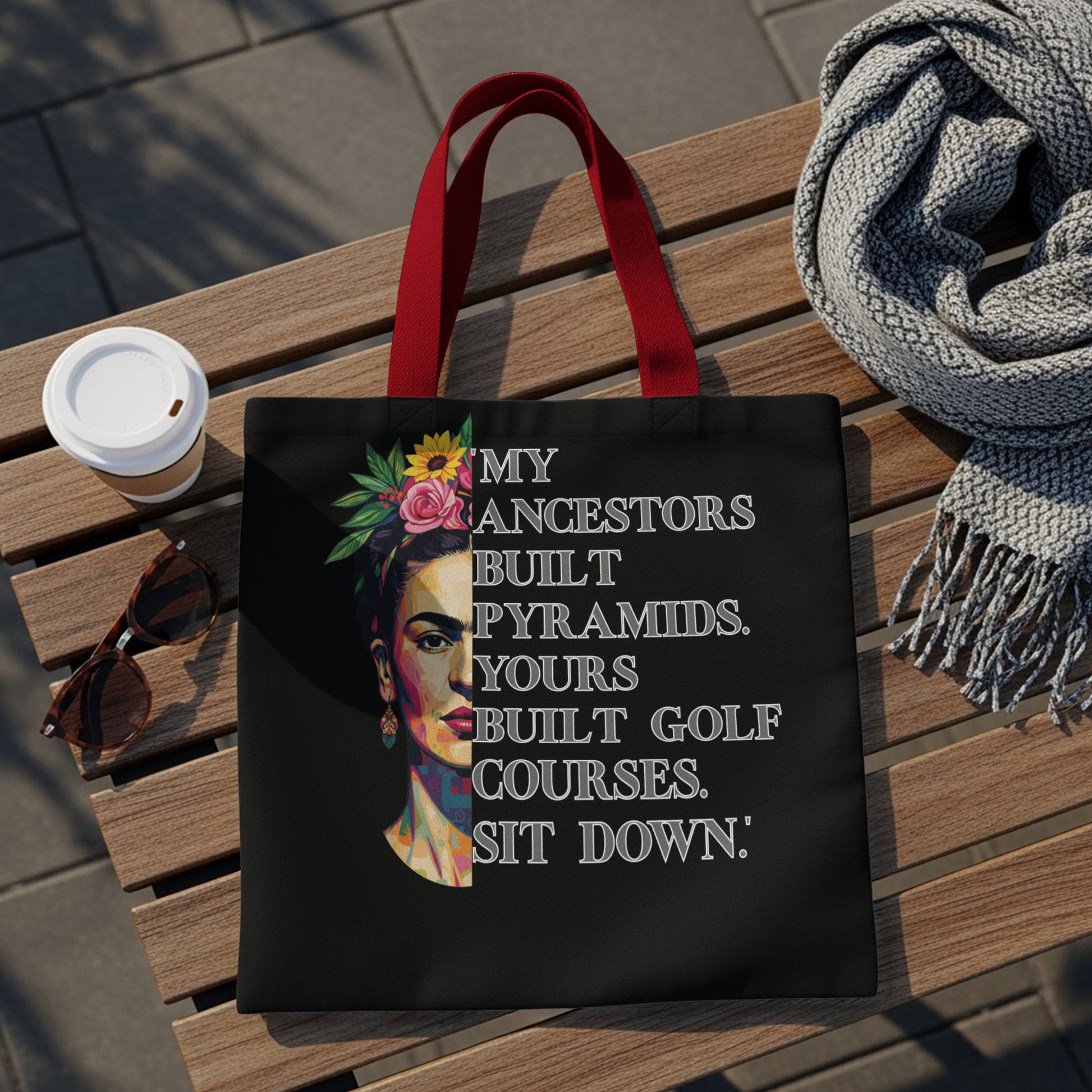 Black tote bag with Frida Kahlo portrait and text about ancestors.