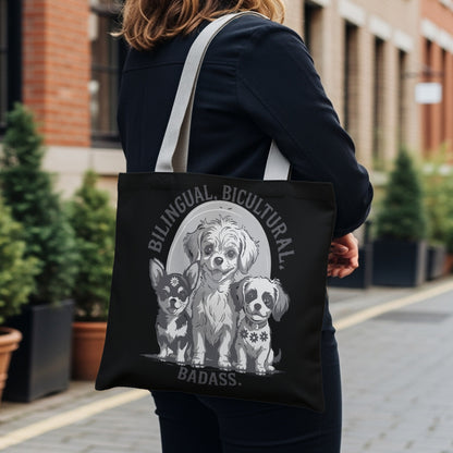 Black tote bag with three illustrated dogs and "Bilingual. Bicultural. Badass." text.