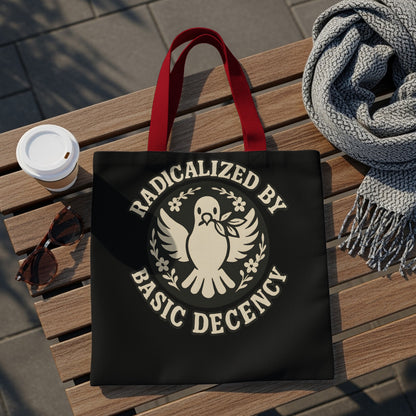 Black tote bag with "Radicalized by Basic Decency" text and dove emblem.