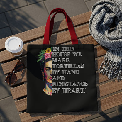 Tote bag with Frida Kahlo portrait and text: "In this house we make tortillas by hand and resistance by heart."