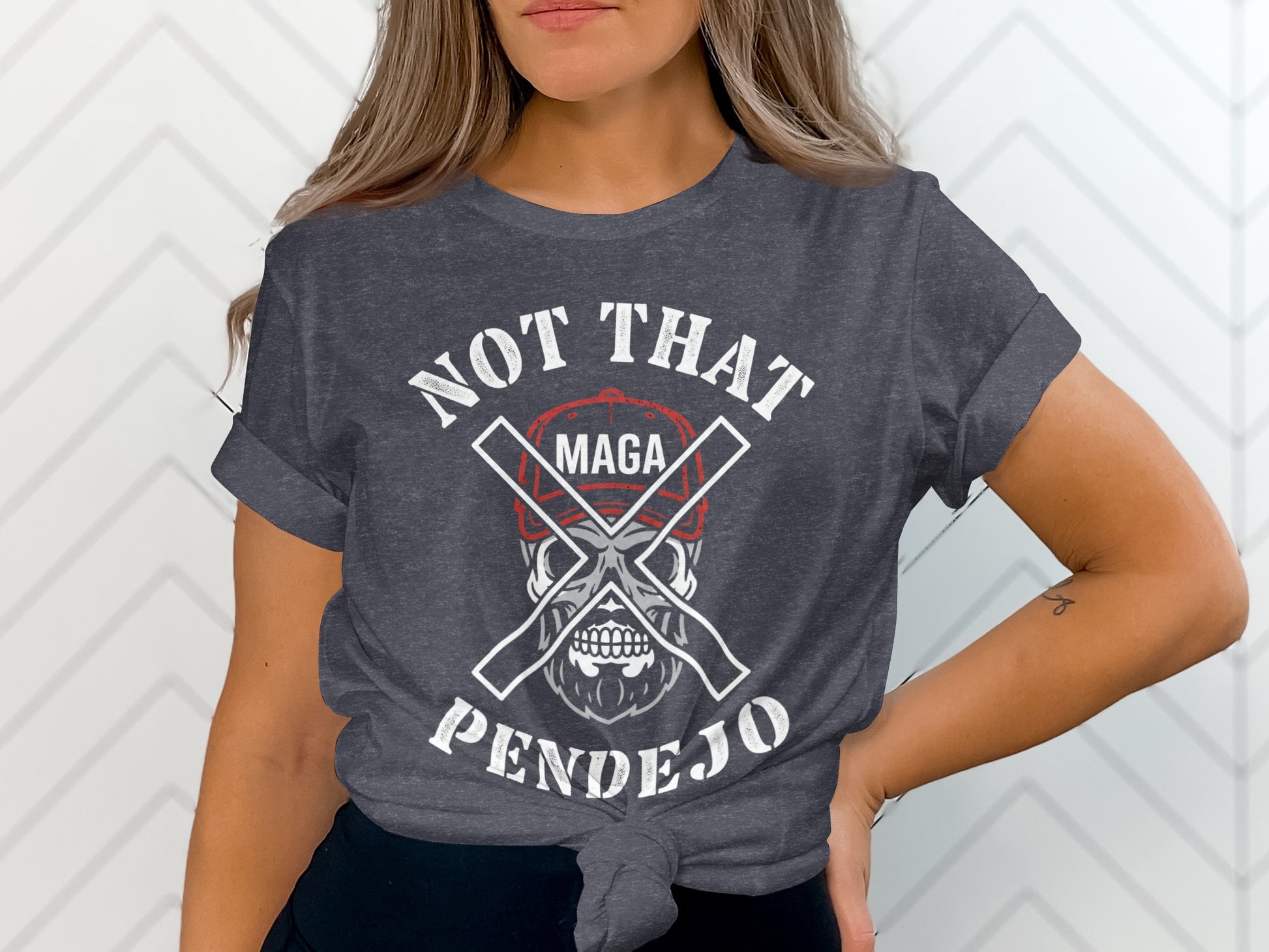 Dark gray t-shirt with "NOT THAT PENDEJO" and crossed bones over a skull.