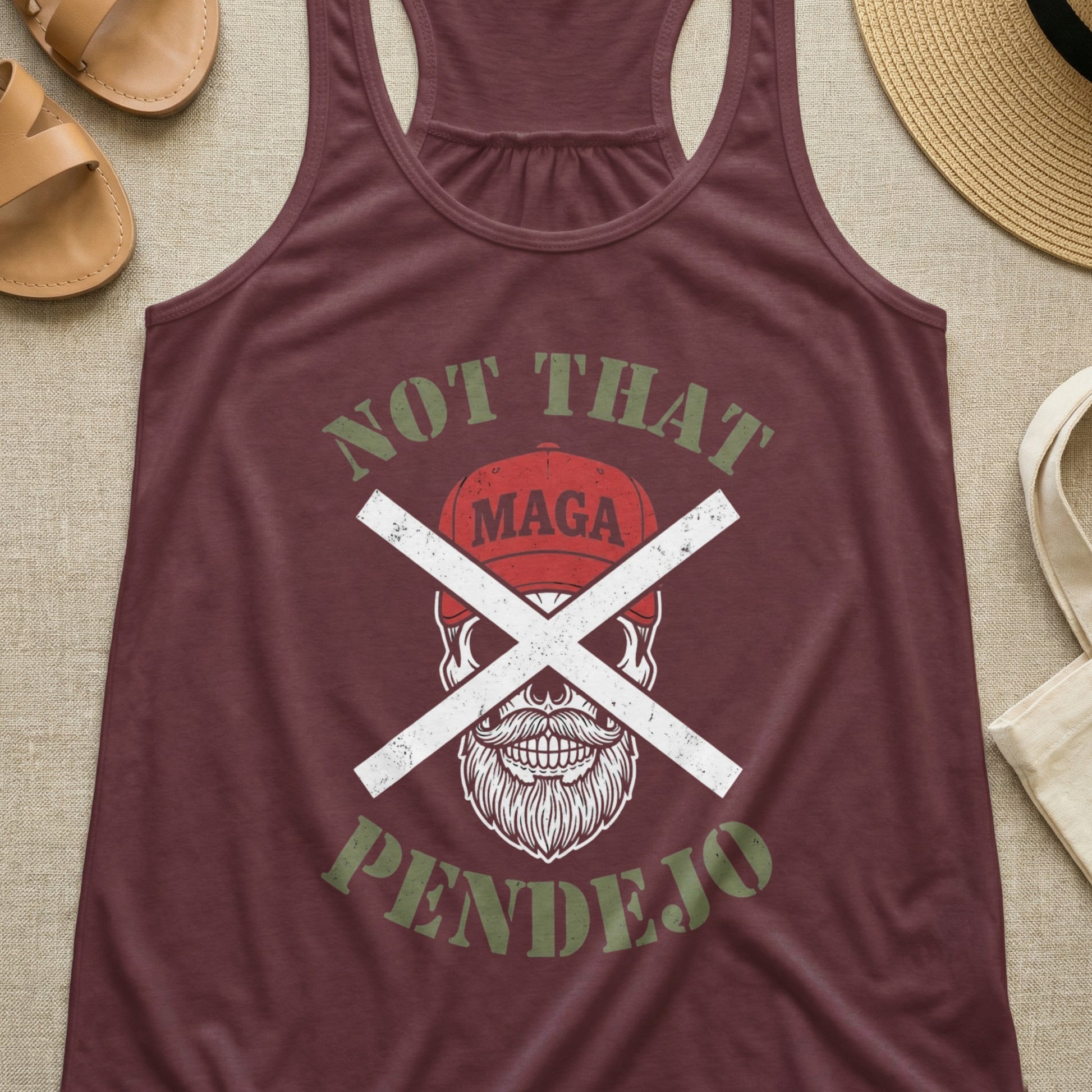 Maroon tank top with "Not That Pendejo" and skull with crossed-out baseball cap graphic.