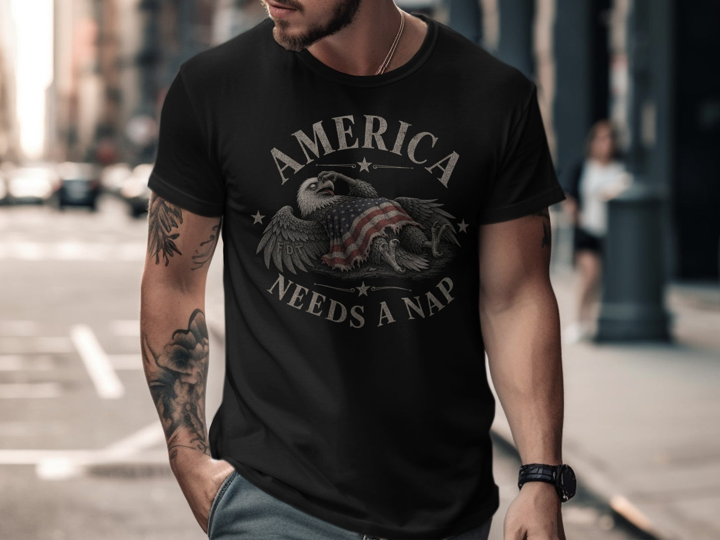 Black t-shirt with distressed eagle and US flag graphic, text reads "America Needs A Nap".