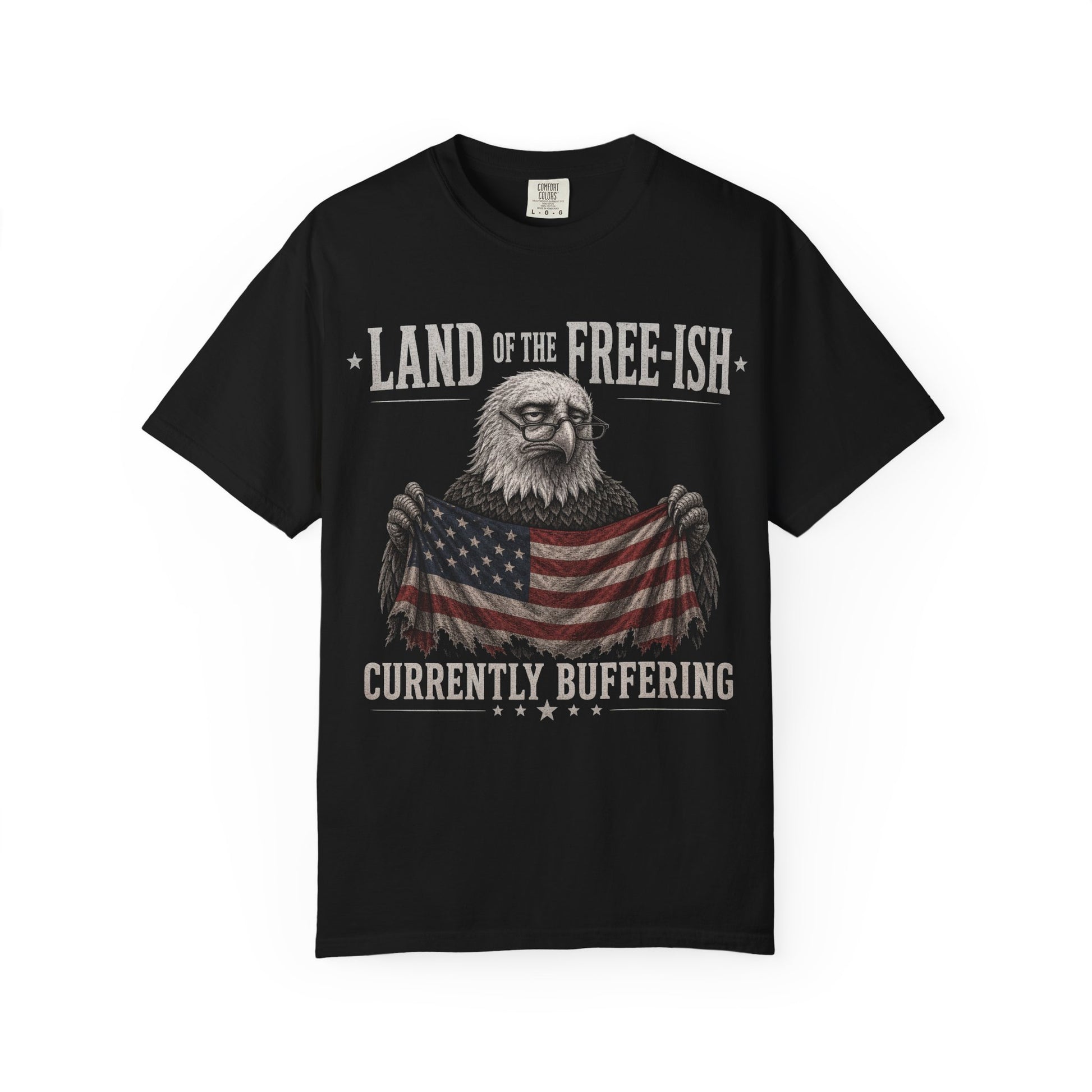 Black t-shirt with an eagle wearing glasses holding an American flag, text "Land of the Free-ish Currently Buffering".