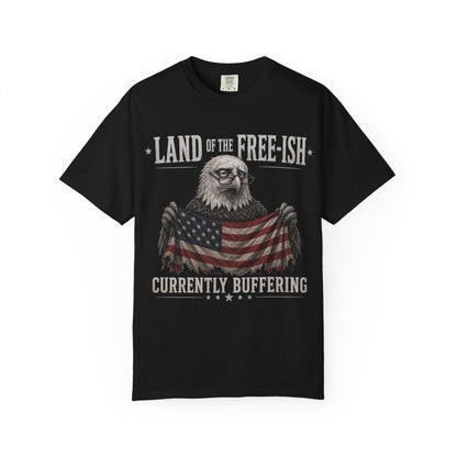 Black t-shirt with an eagle wearing glasses holding an American flag, text "Land of the Free-ish Currently Buffering".