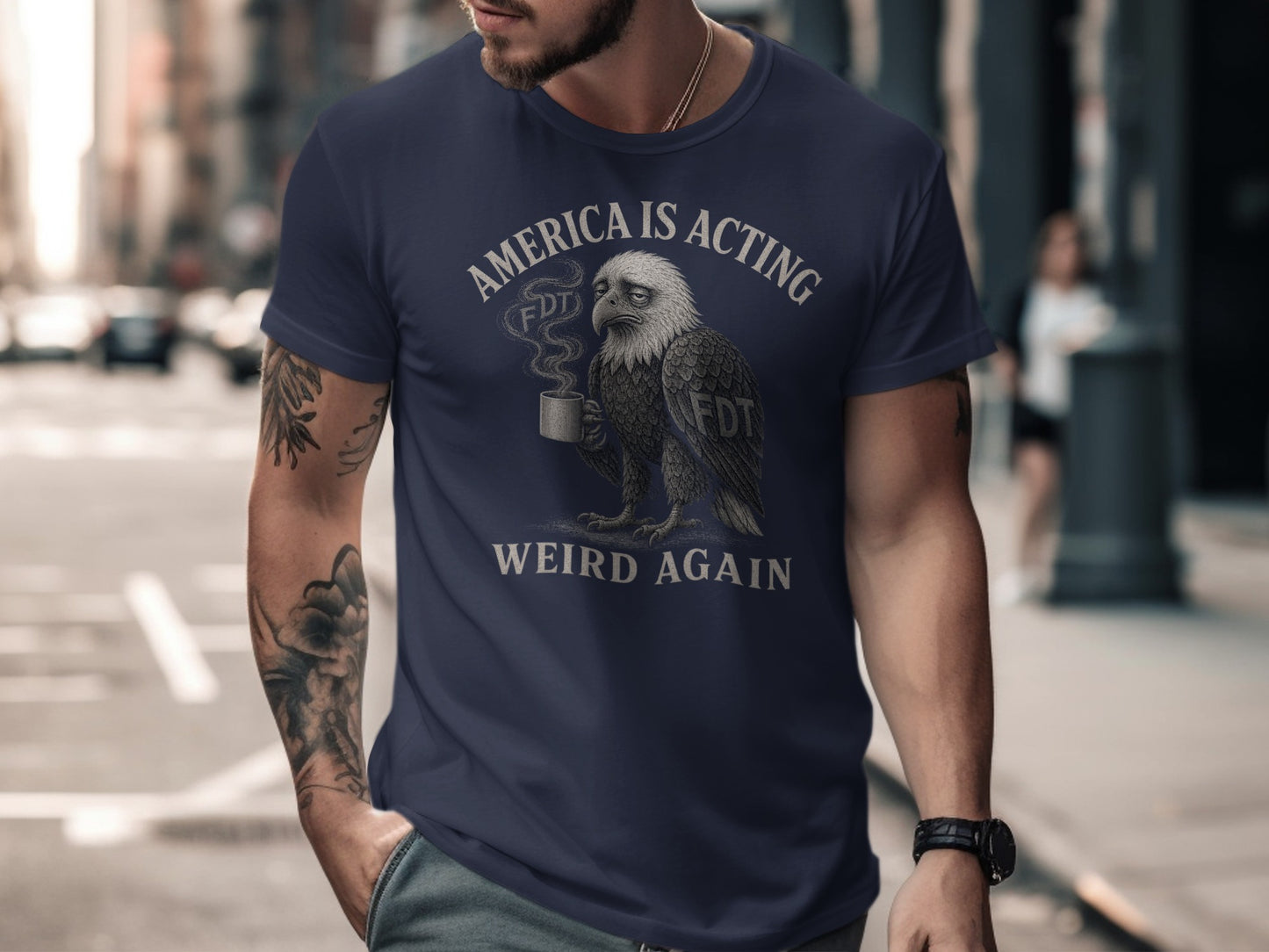 T-shirt with an eagle drinking coffee and text "America is Acting Weird Again".