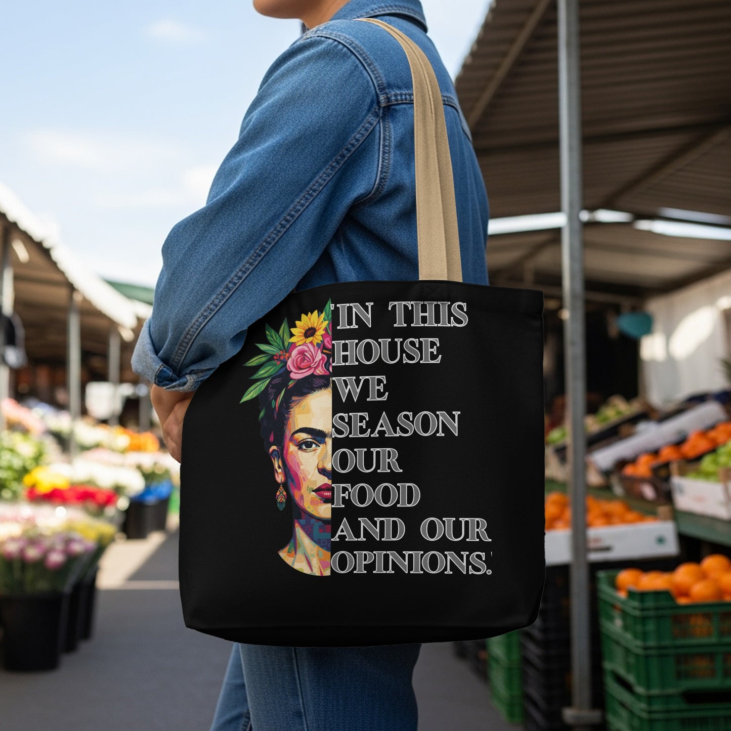 Black tote bag with Frida Kahlo graphic and text "In this house we season our food and our opinions."