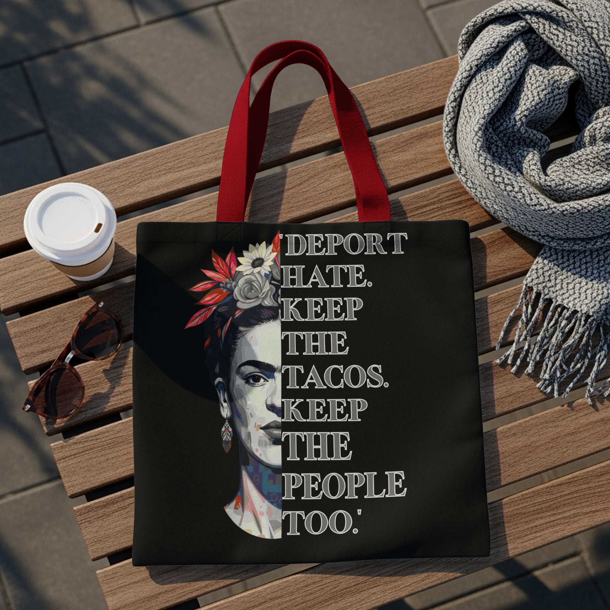 Black tote bag with Frida Kahlo artwork and "Deport hate. Keep the tacos. Keep the people too."