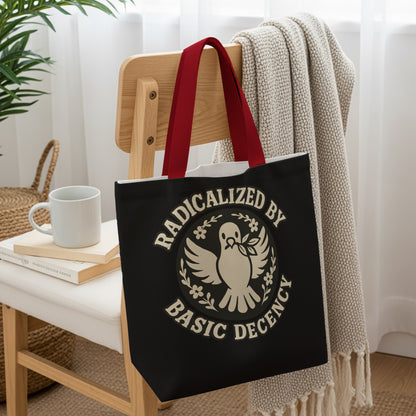 Black tote bag with "Radicalized by Basic Decency" slogan and dove emblem.