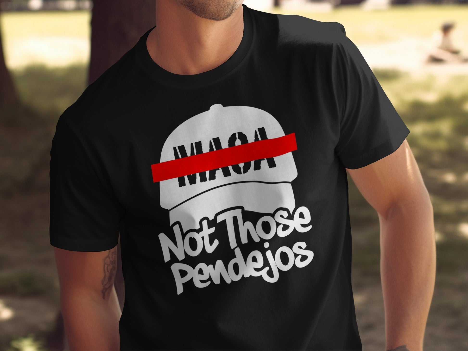 Black t-shirt with white text and a red stripe across a white cap graphic.