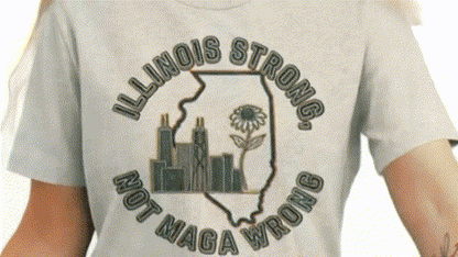 A person wearing a gray t-shirt with a graphic design that says "Illinois Strong. Not MAGA wrong" around a graphic of the state of Illinois.