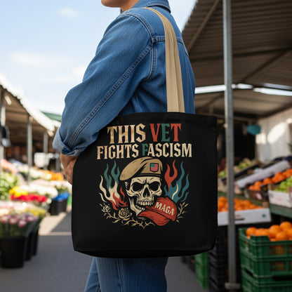 Black tote bag with skull wearing beret, American flag, and text "This vet fights fascism MAGA."