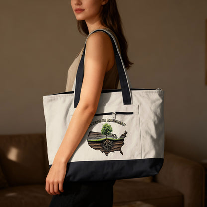 Tote bag with "Powered by Immigrants" text and U.S. map graphic.