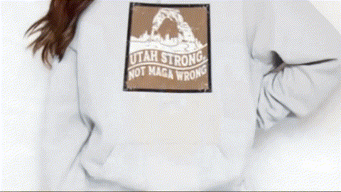 A person wearing a white sweatshirt with a graphic design on the back.