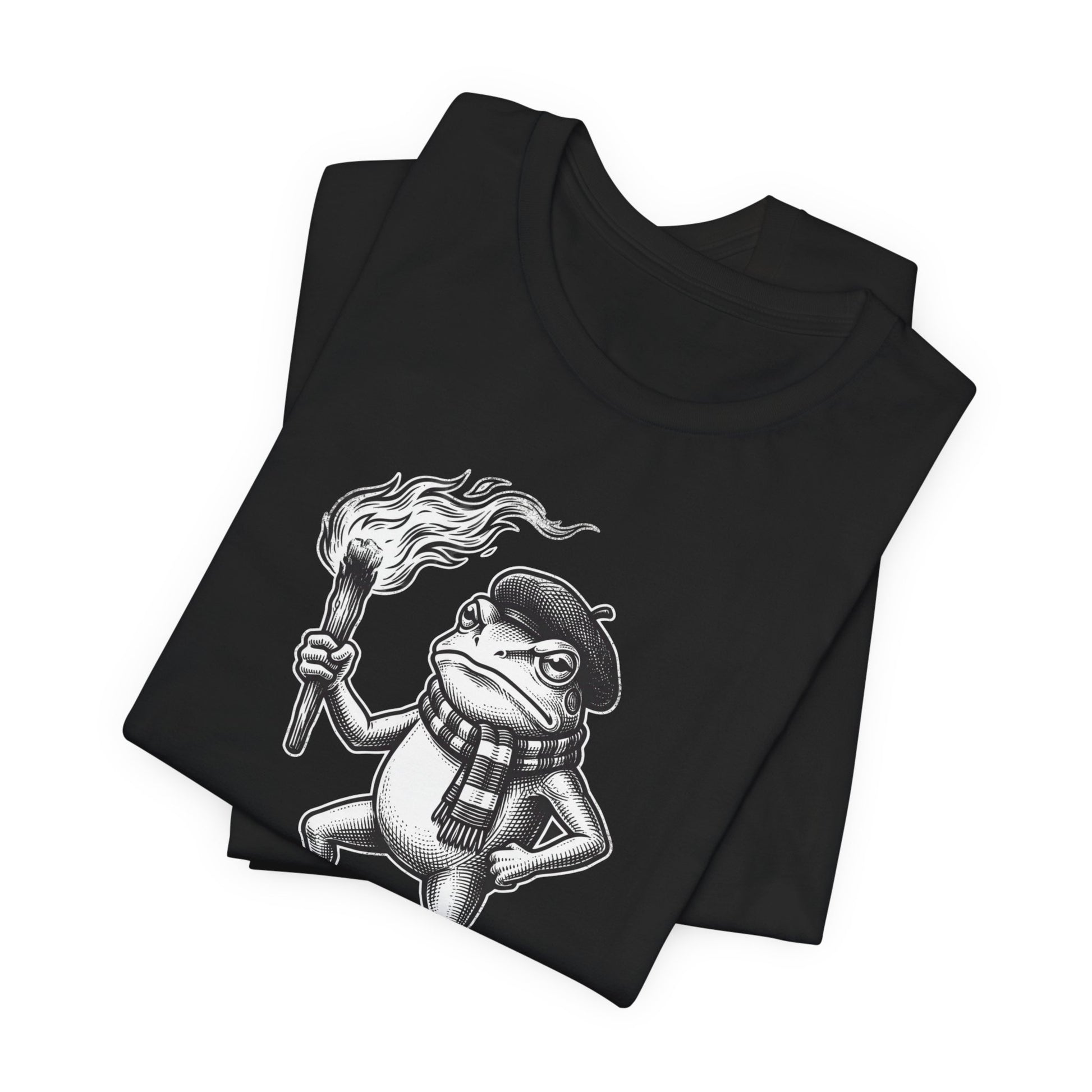 Black t-shirt featuring a cartoon frog wearing a beret and scarf holding a torch.