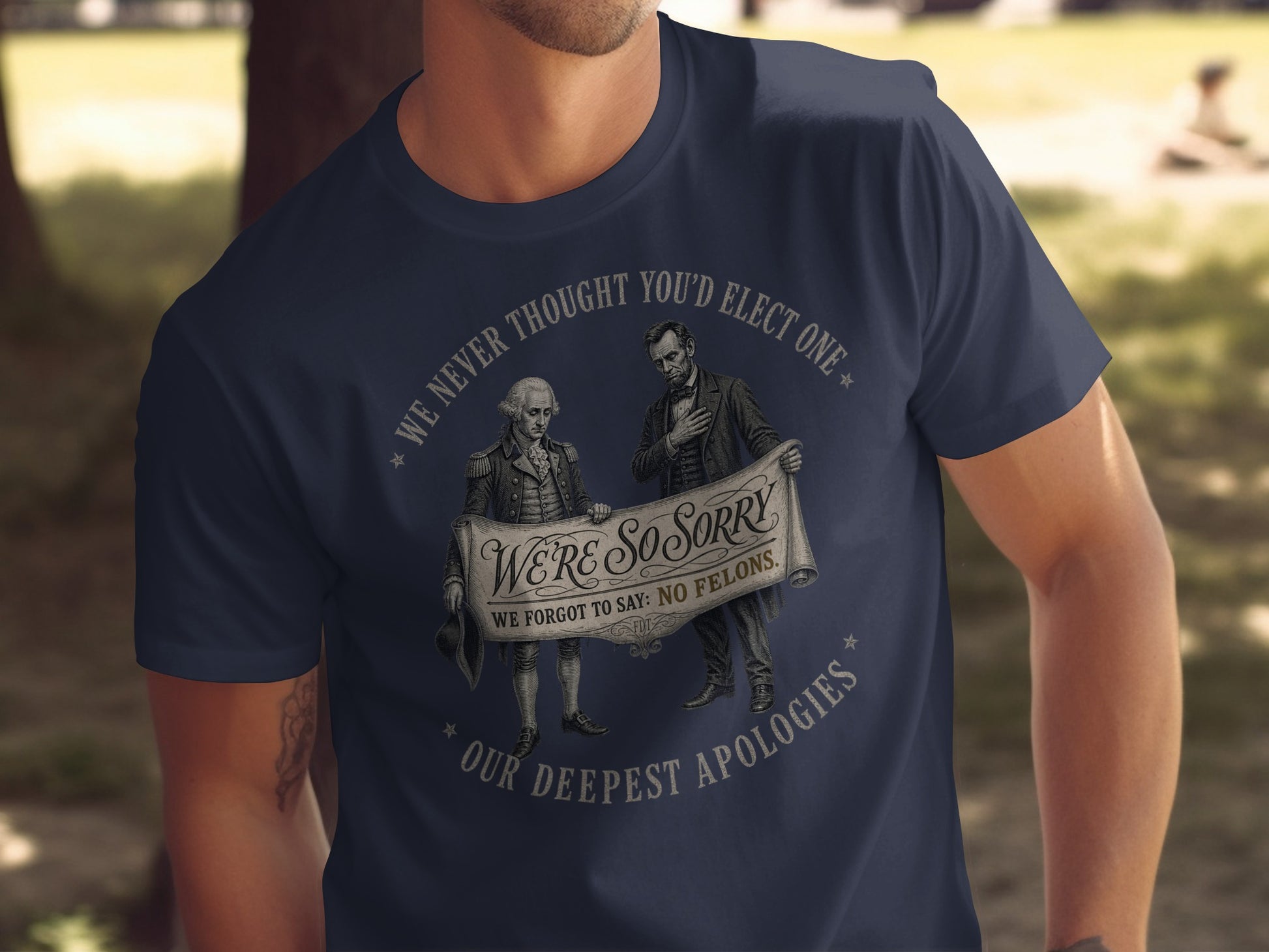 T-shirt with George Washington and Abraham Lincoln holding banner stating "We're so sorry we forgot to say: No felons."