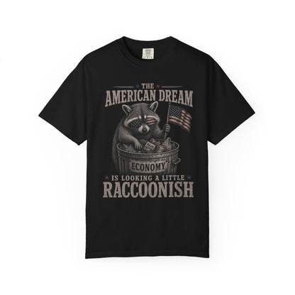 T-shirt with raccoon wearing sunglasses, holding American flag and money, text reads "The American Dream Economy is Looking a Little Raccoonish".