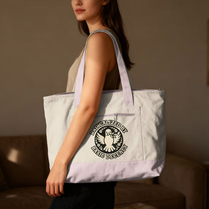 Tote bag with "Radicalized by Basic Decency" text and dove emblem.