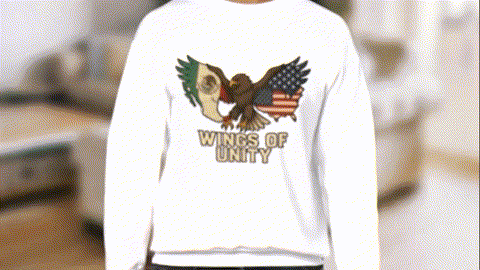 A person wearing a white sweatshirt with an embroidered design of an eagle and the text "WINGS OF UNITY" printed on it.
