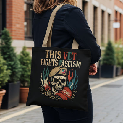 Black tote bag with skull, flag, and "This Vet Fights Fascism" text.