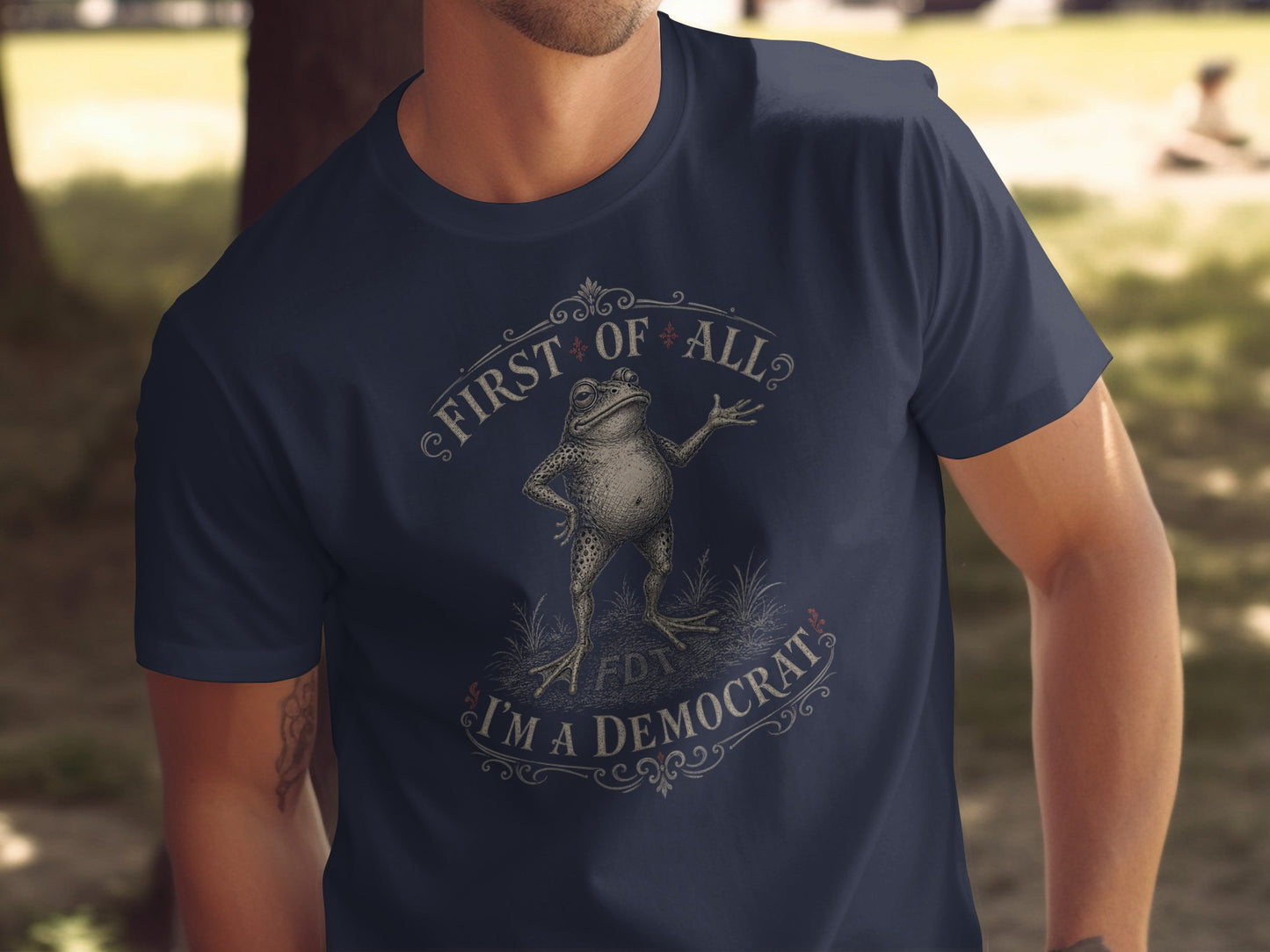 Dark blue t-shirt with a frog illustration and the text "First of all, I'm a Democrat".