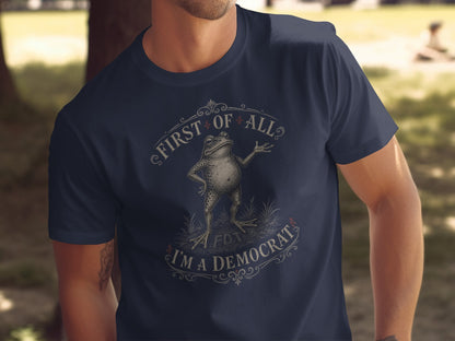 Dark blue t-shirt with a frog illustration and the text "First of all, I'm a Democrat".