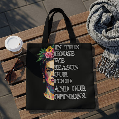 Black tote bag with Frida Kahlo portrait and text "In this house we season our food and our opinions."