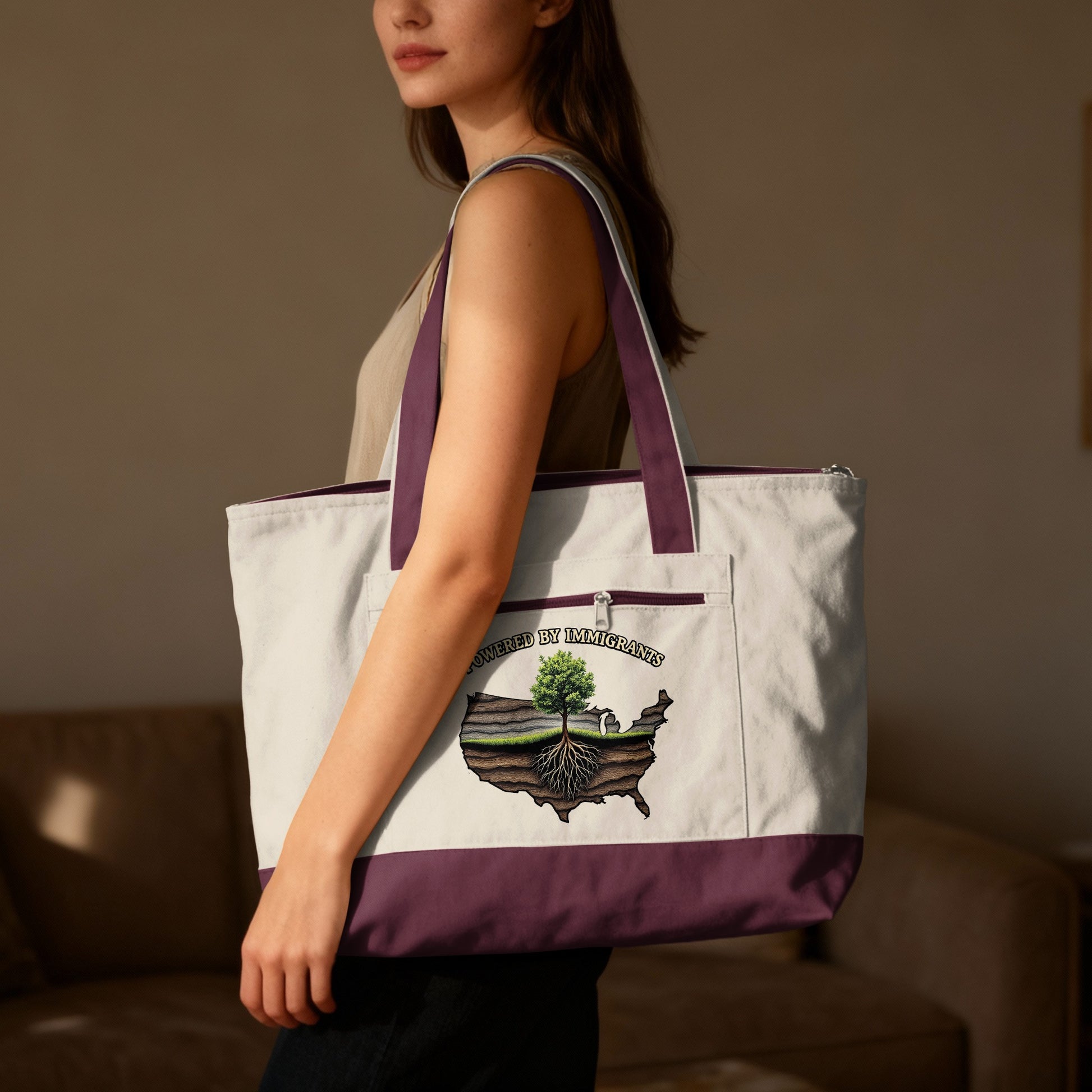 Tote bag with "Powered by Immigrants" text and a USA map graphic featuring a tree.