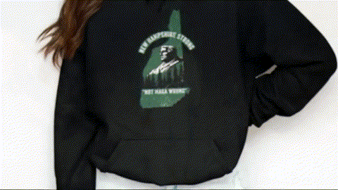 A person wearing a black hoodie with a graphic design on the back.