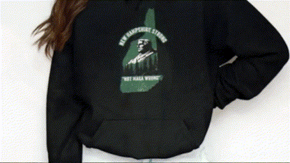 A person wearing a black hoodie with a graphic design on the back.