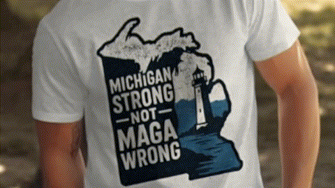 A white t-shirt with a graphic design depicting a lighthouse and the text "Michigan Strong Not MAGA Wrong" printed on it.