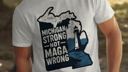 A white t-shirt with a graphic design depicting a lighthouse and the text "Michigan Strong Not MAGA Wrong" printed on it.