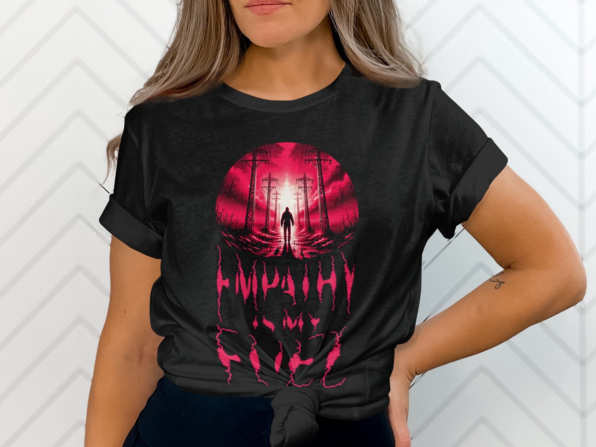 Black t-shirt with red graphic of silhouetted figure against power lines and glowing sun.