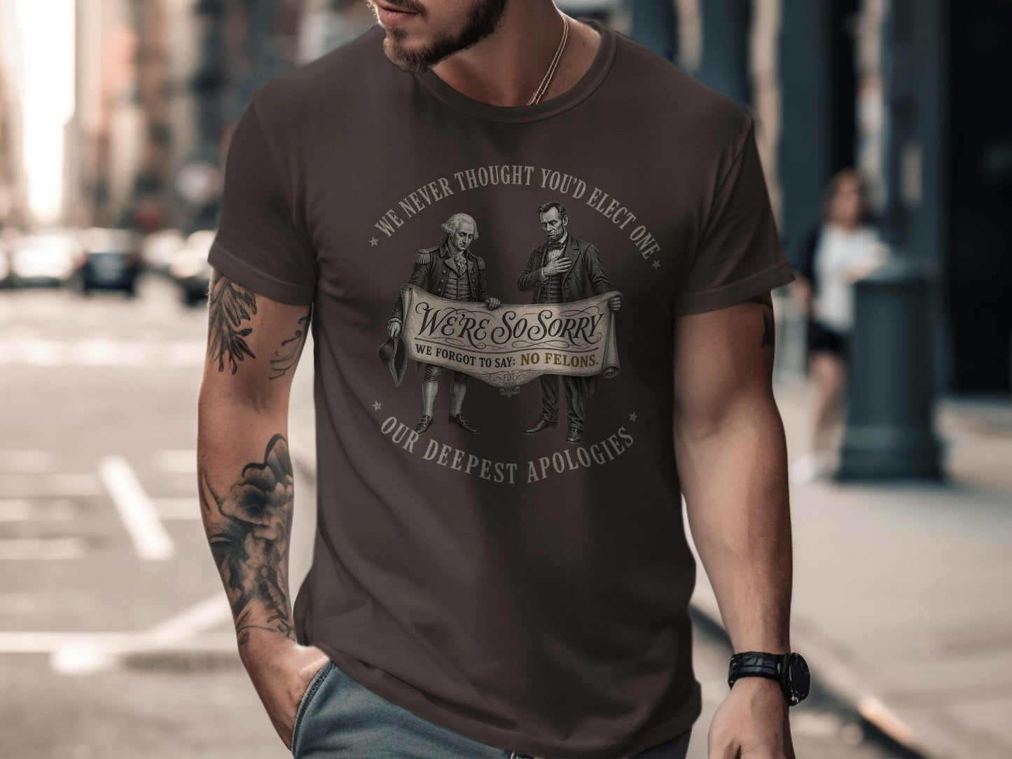 T-shirt with "WE'RE SO SORRY WE FORGOT TO SAY: NO FELONS." slogan.