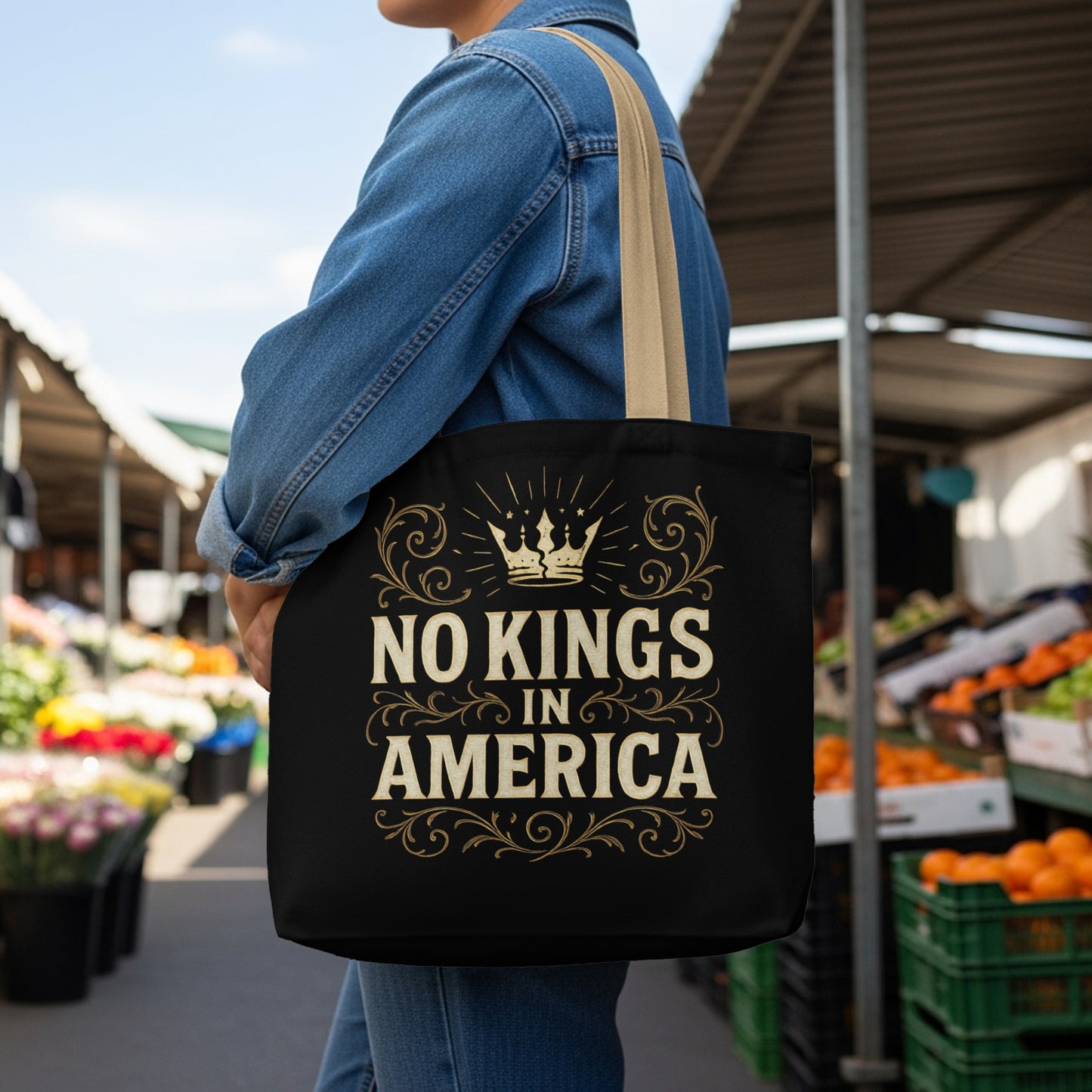 Black tote bag with "NO KINGS IN AMERICA" text and crown design.