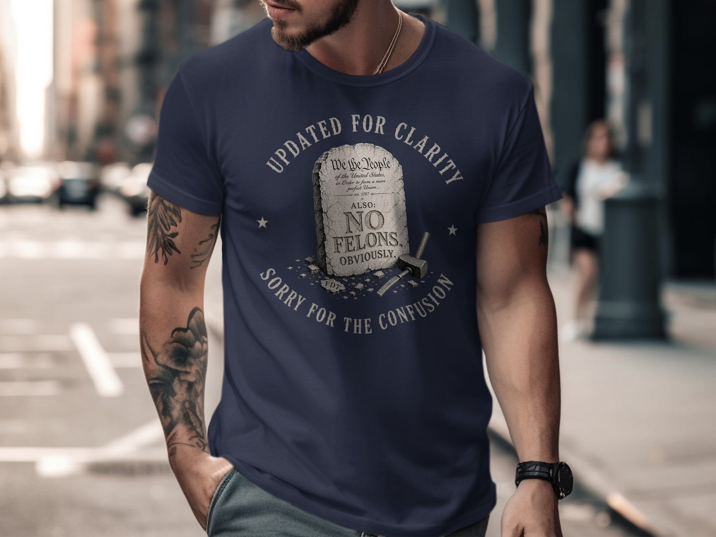 Navy t-shirt with "Updated for Clarity" text and "No Felons" slogan.