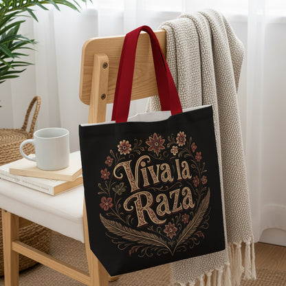 Black tote bag with "Viva La Raza" text surrounded by floral and feather design.