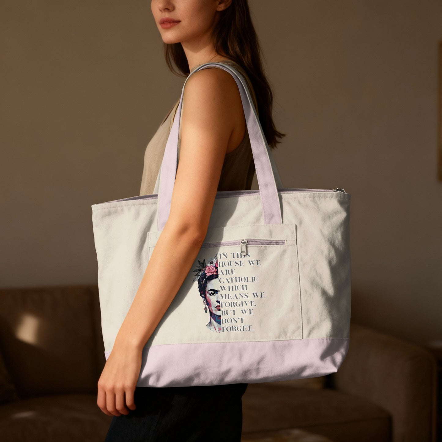Tote bag with Frida Kahlo graphic and text "In this house we are Catholic which means we forgive. But we don't forget."