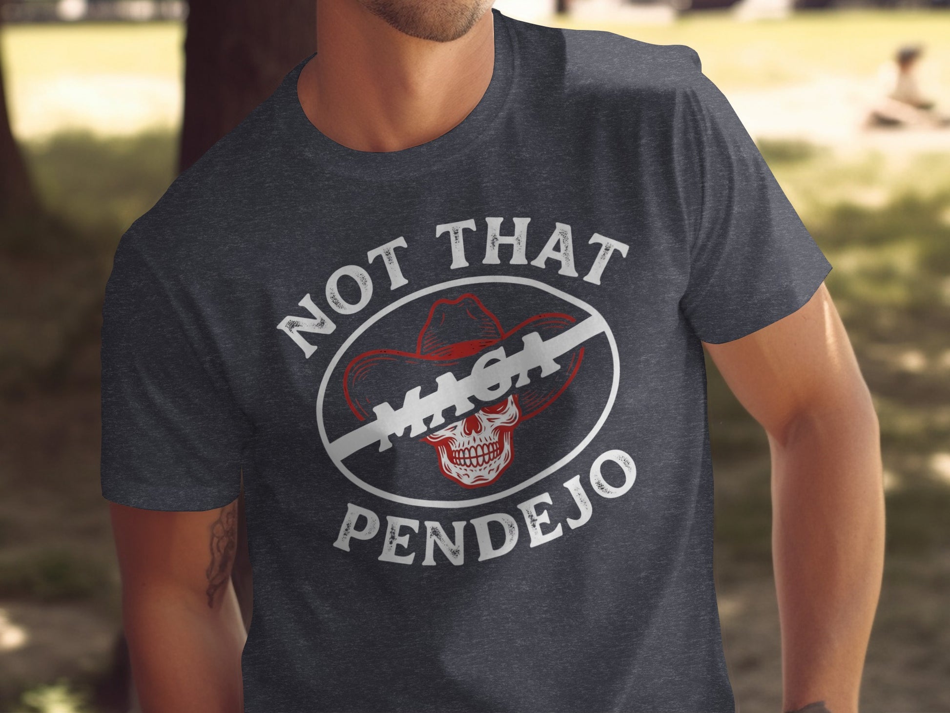 Dark t-shirt with a graphic of a skull wearing a cowboy hat and the text "NOT THAT MAGA PENDEJO".