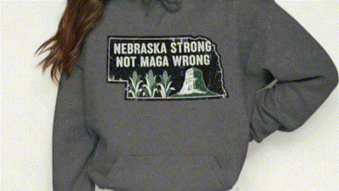 A person wearing a grey hoodie with a graphic design on it.