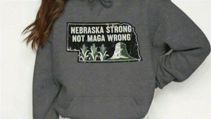 A person wearing a grey hoodie with a graphic design on it.