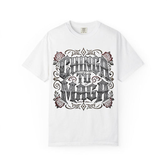 A white t-shirt with a graphic design featuring the text "CHINÁ TI MÁGA" surrounded by decorative elements such as roses and swirls.