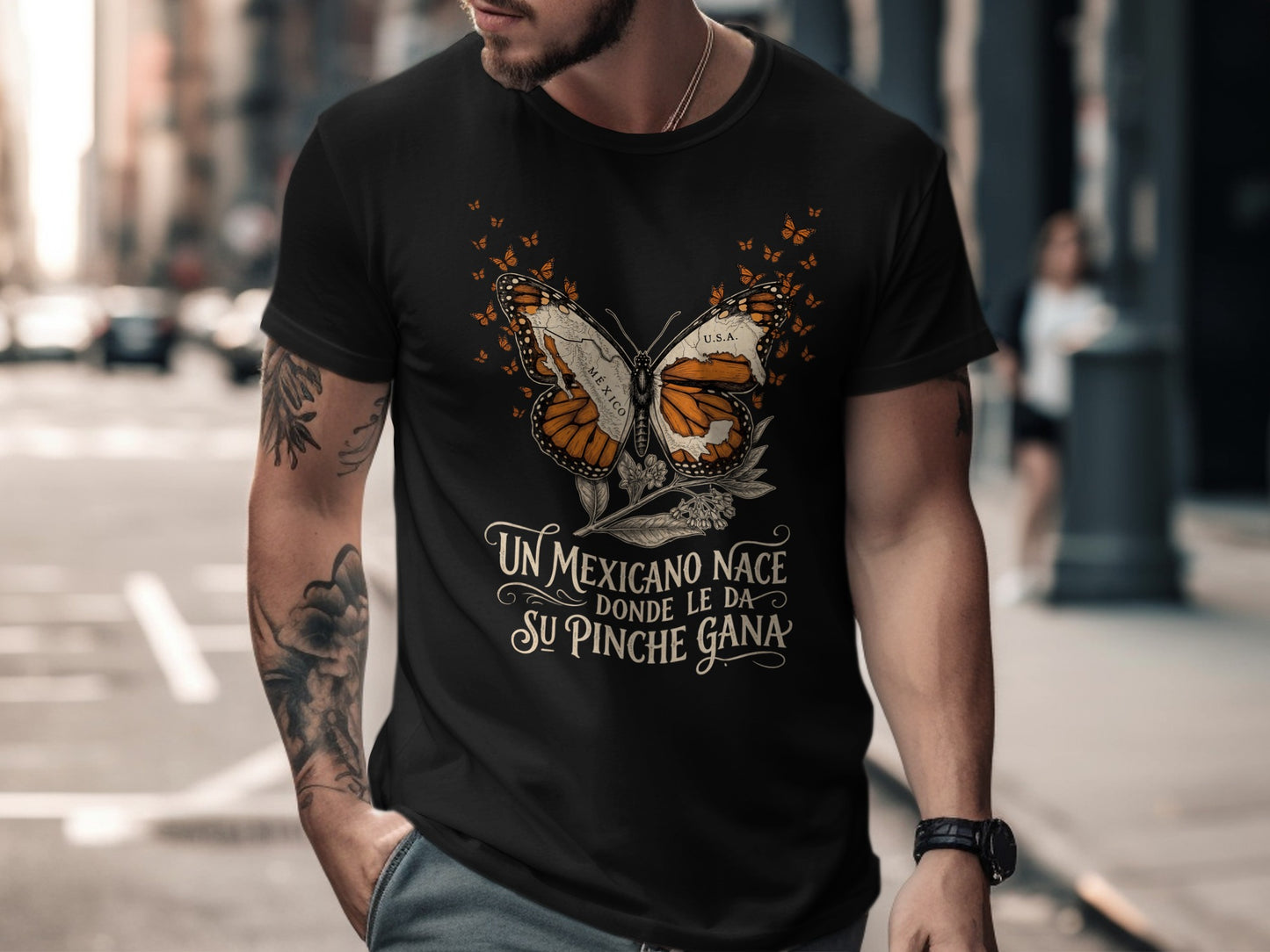 Black t-shirt with a butterfly design and Spanish text reading "Un Mexicano Nace Donde Le Da Su Pinche Gana".