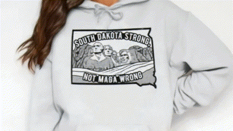 A person wearing a grey hoodie with a graphic design featuring a political statement.